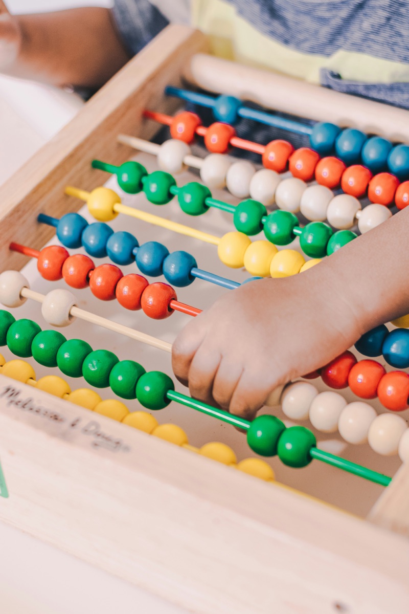 A child learning with a colorful abacus